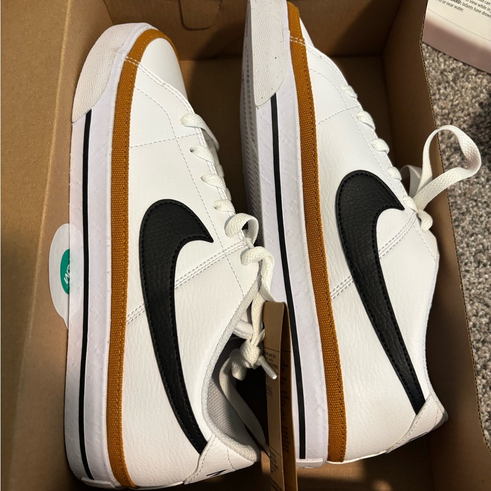 Nike Women's White and Black Sneakers with Gold Trim